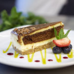 Chocolate layered cheese cake, strawberries and blueberries on the side