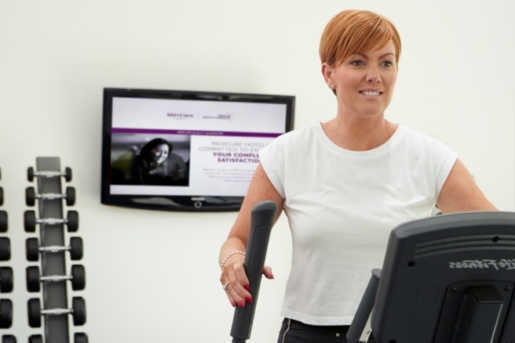 Woman using cross trainer in the gym at Mercure Sheffield Parkway Hotel