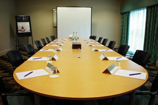 The Boardroom meeting room at Mercure Sheffield Parkway Hotel, projector screen, flipboard, bottled water, stationery