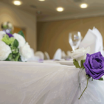 Purple rose detail on wedding breakfast table place setting