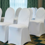An event suite at Mercure Sheffield Parkway Hotel set up for a wedding ceremony, white lace chair covers