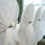 An event suite at Mercure Sheffield Parkway Hotel set up for a wedding ceremony, close up of white lace chair covers