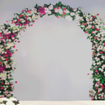 An event suite at Mercure Sheffield Parkway Hotel set up for a wedding ceremony, painted flowery arch