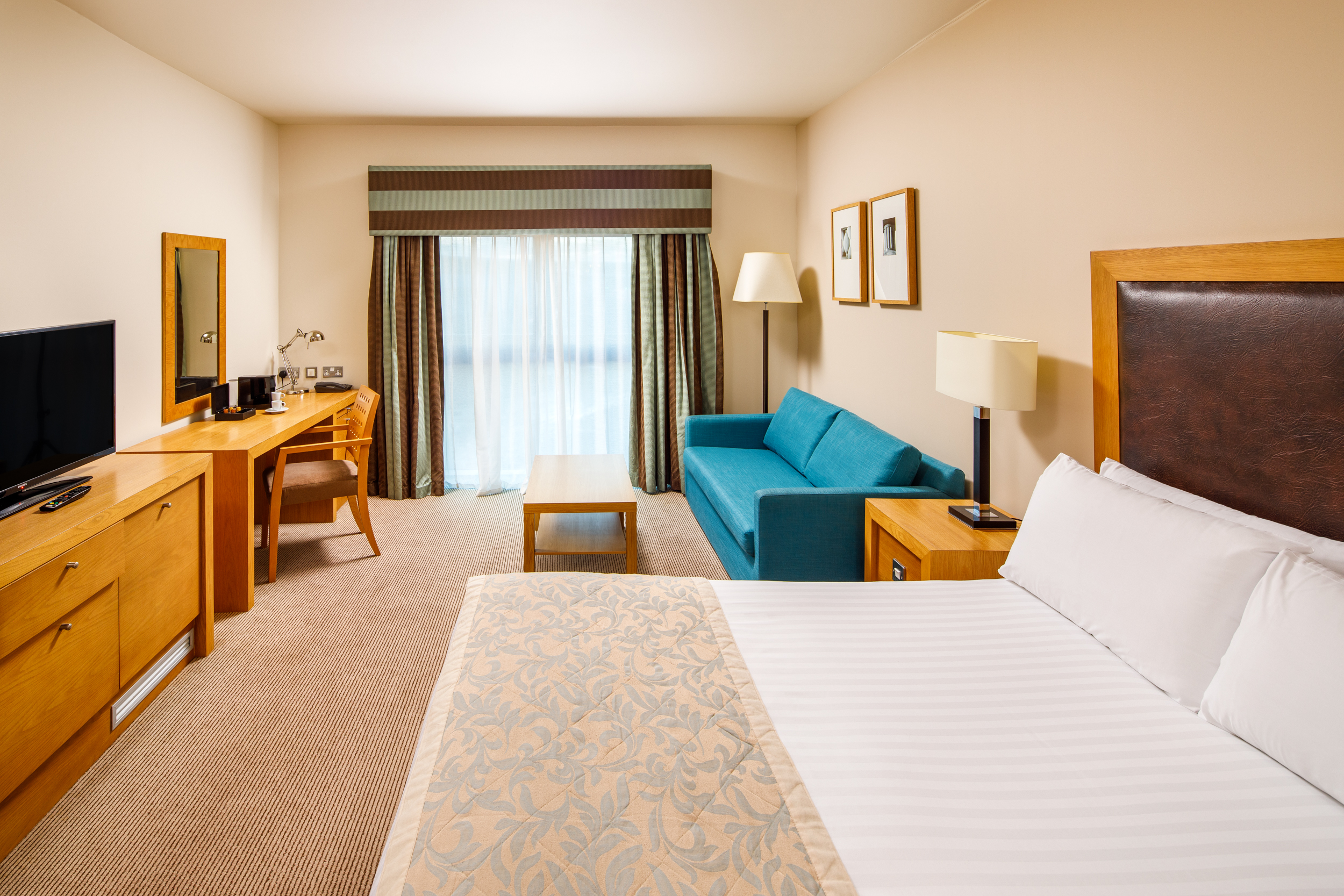 Double bed and headboard in a Privilege Room at Mercure Hotels